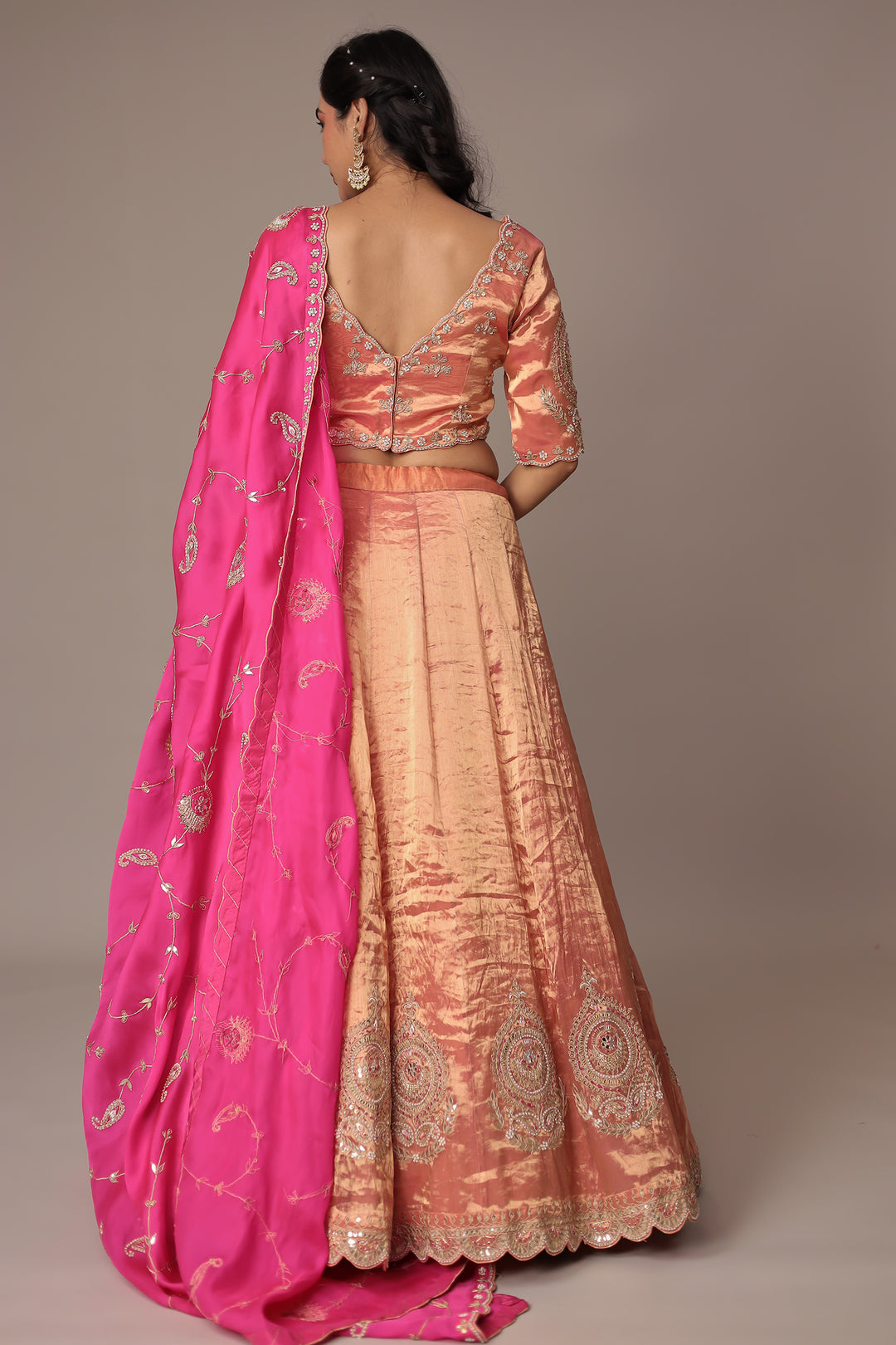 Peach Shimmer Tissue Lehenga with Intricate Gota Patti, Pearl & Zardozi Embellishments Paired with a Contrasting Pink Dupatta